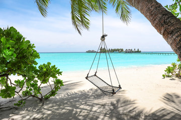 Canvas Print - View of beach with swings at tropical resort