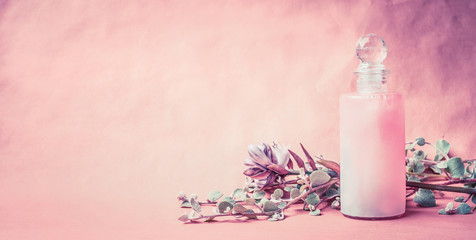 Wall Mural - natural cosmetic product in bottle with herbs and flowers on pink background, front view, banner, pl