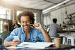 © wayhome.studio  - Stylish Afro American male student working at cafeteria doing his home assigment having glad expression while receiving good news on his mobile phone finding out that he can be free tomorrow