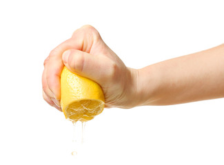 Wall Mural - Female hand squeezing half of lemon on white background