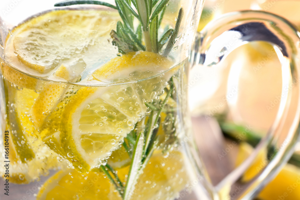 Jug of fresh lemonade with rosemary, close up