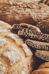 Bread background, closeup of white, black and rye loaves