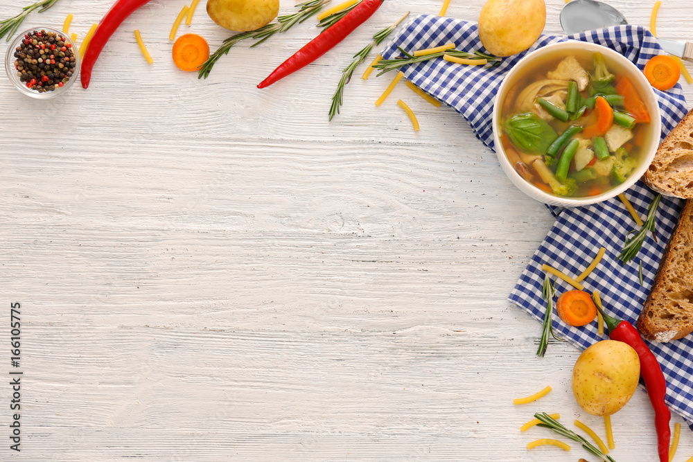 Bowl with delicious turkey soup on wooden background