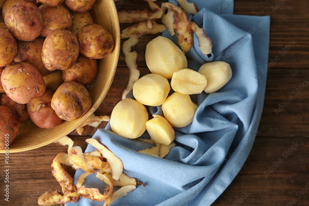 Composition with raw organic potatoes on wooden table