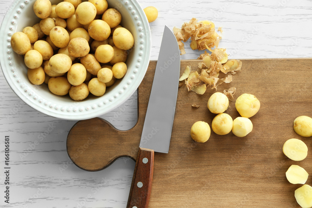 Composition with raw organic potatoes on wooden table