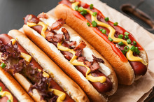 Barbecue Grilled Hot Dogs With  Yellow American Mustard, On A Dark Wooden Background
