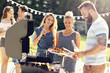 © Kalim - Friends having barbecue party in backyard