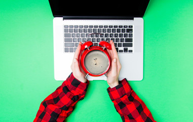 Wall Mural - Female holding alarm clock with coffee inside