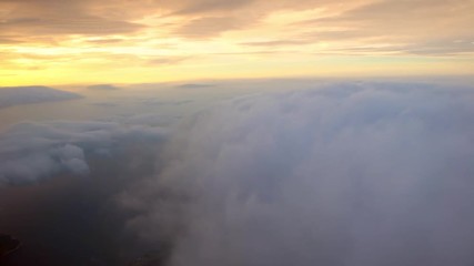 Wall Mural - 4K Traveling by air. Wonderful view of Busan, the sky and clouds with the sun from above, as seen through an airplane window with sunset-Dan