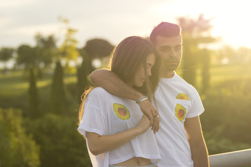 Teen couple holding at sunset