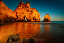 A Long Exposure, Golden Hour Sunset Picture Of The Alvor Beach In Algarve, Portugal