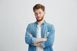© Cookie Studio - Portrait of young handsome man with crossed arms looking at camera smiling over white background.
