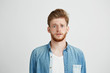 © Cookie Studio - Young handsome guy looking at camera naively hopefully over white background.
