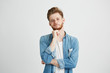 © Cookie Studio - Portrait of confident young handsome man with beard looking at camera thinking with hand on chin over white background.