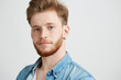 © Cookie Studio - Portrait of young sincere attractive guy smiling looking at camera over white background.