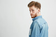 © Cookie Studio - Portrait of young handsome man smiling looking turning to camera over white background.