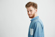 © Cookie Studio - Portrait of young handsome man smiling looking turning to camera over white background.