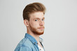 © Cookie Studio - Close up portrait of young handsome hipster man with beard wearing jean shirt looking at camera over white background.