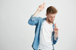 © Cookie Studio - Young positive handsome man in headphones listening to music dancing moving over white background.