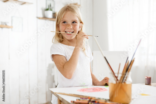 Little Girl With Blonde Hair And Freckles Enjoying Art Wearing