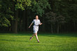 © Sergey Chumakov - happy brunette woman run in forest green lawn at sunny day