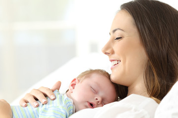 Wall Mural - Joyful mother sleeping with her baby