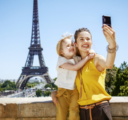 Wall Mural - mother and daughter taking selfie with digital camera in Paris