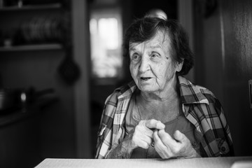 Wall Mural - An elderly woman says bending his fingers.