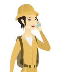 Poster - Young asian traveler talking on a mobile phone.