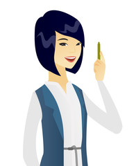 Canvas Print - Young asian smiling business woman with a pen.