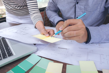 Poster - Two colleagues interior Creative creativity graphic designer working with graphics laptop, blueprint and colour chart at workplace on wooden desk , colour ideas style concept