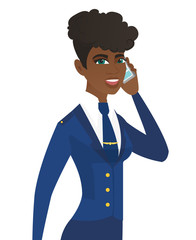 Canvas Print - Young african stewardess talking on a mobile phone