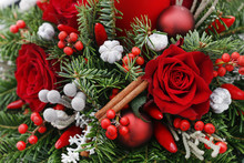 Christmas Decoration With Candle, Red Roses, Fir, Brunia And Cinnamon Sticks.