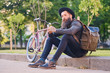© Fxquadro - A man sits on a step and using a smartphone.