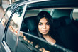© Jacob Lund - Beautiful young businesswoman travelling by a car