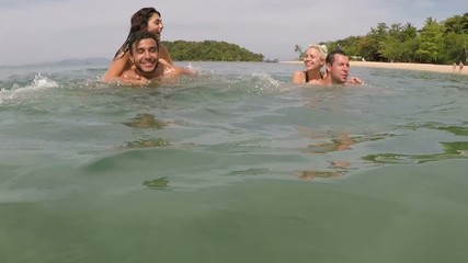 Wall Mural - Happy People Having Fun Swimming In Sea Action Camera POV Of Young Playful Friends Group Together On Beach During Summer Vacation