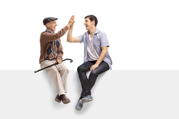 Canvas Print - Senior and young guy on a panel high-fiving each other