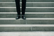 © Augustino - Men fashion, movie star concept. Standing on stone stairs man wearing black pants and patent leather shoes. Iconic classic Hollywood style. Outdoor shot