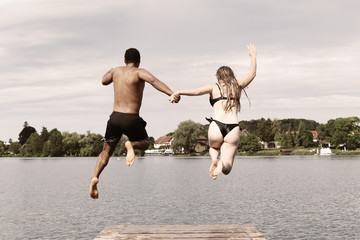 Couple Jumping Into Lake