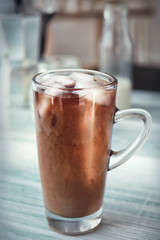 Wall Mural - Glass cup with cold brew coffee and milk on light background