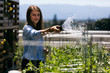 © seanlockephotography - Workspace: Woman Taking A Break From Work Waters Rooftop Garden