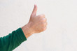 © mimagephotos - Close up male hand with thumbs up isolated on white background