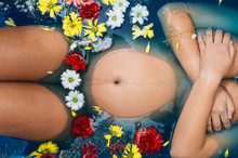 Pregnant Woman's Body In Floral Milk Bath