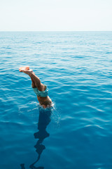 Young man jumping into the water