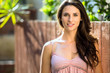 © elnariz - Portrait of a beautiful natural woman outside her home in the courtyard garden on a sunny day