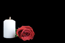 White Candle And Red Rose Isolated On Black Background