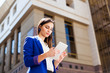 © IVASHstudio - Girl checks her tablet standing on the street
