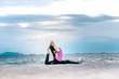 © Kiattisak - Young asian yoga exercise with posting on the beach in summer outdoor
