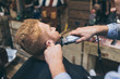 © LIGHTFIELD STUDIOS - barber trimming customers beard