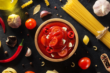 Wall Mural - tomato sauce in bowl on black background